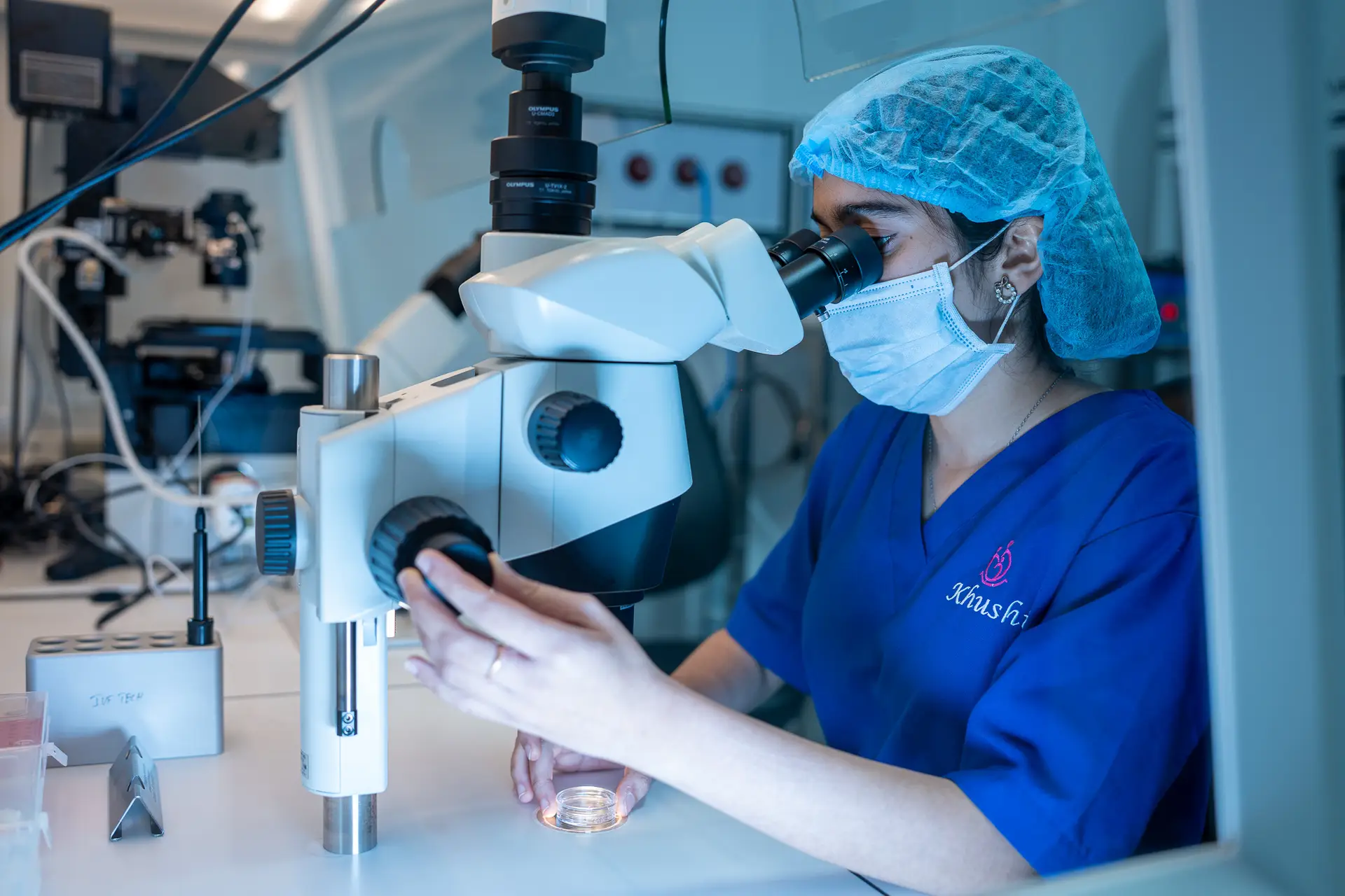 Embryologist examining a sample under a microscope in the IVF laboratory at Khushi Fertility & IVF Centre, Bengaluru.