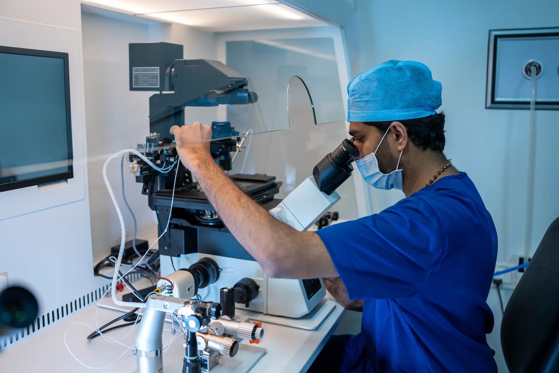 Embryologist working with advanced microscope equipment inside the IVF laboratory at Khushi Fertility & IVF Centre, Bengaluru.